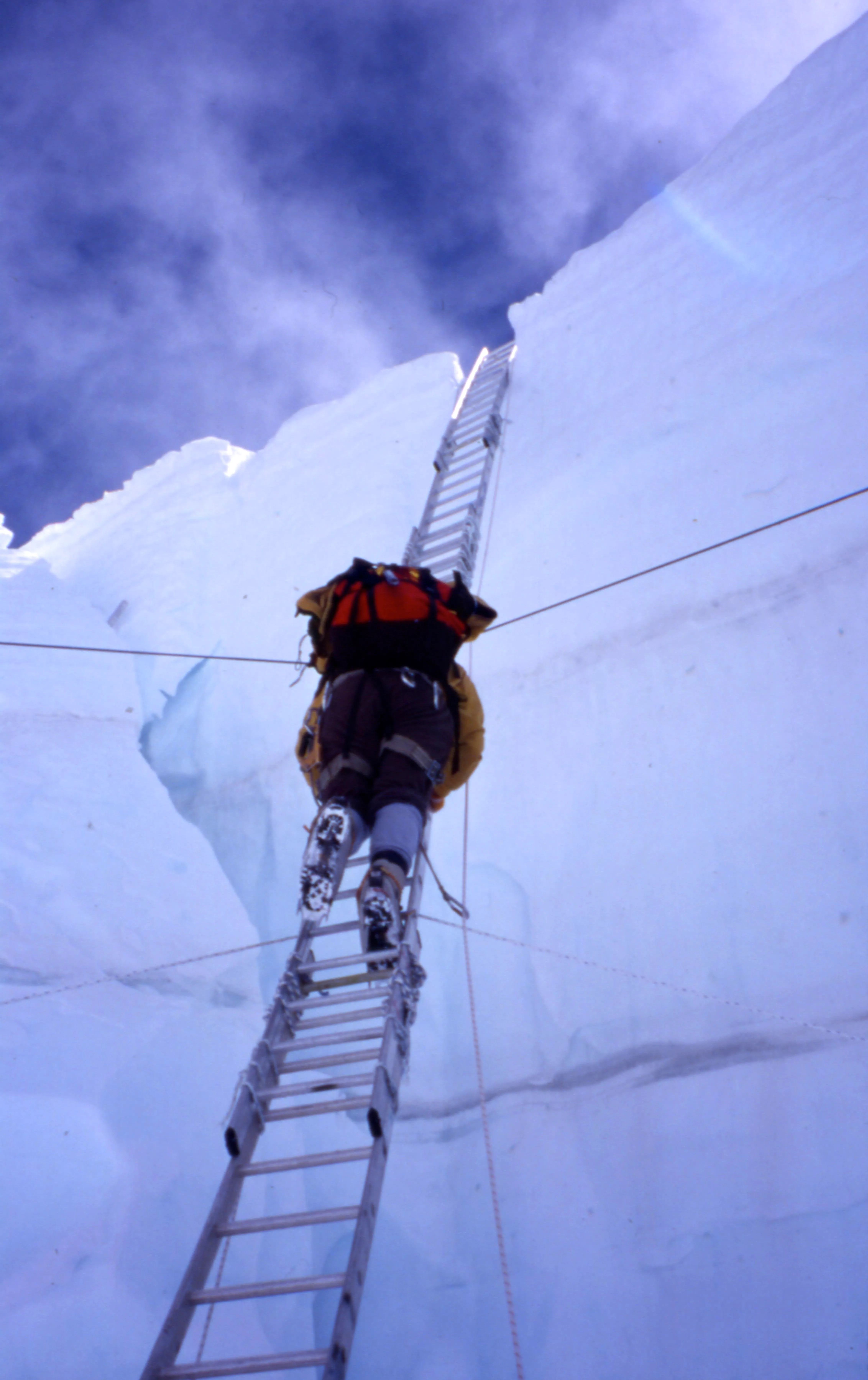Tom climbing on a ladder on Khumbu Icefall.